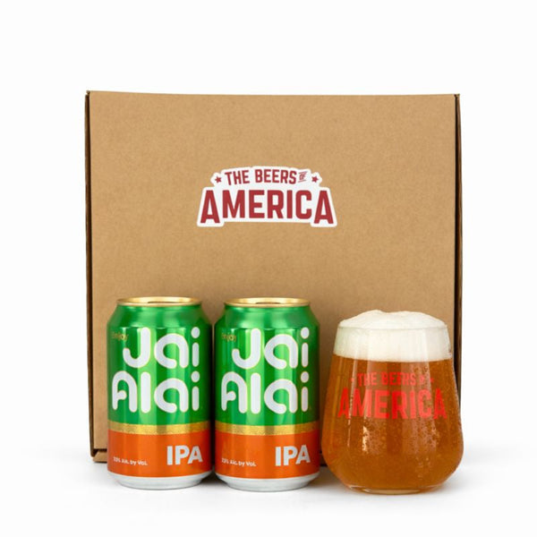 Two cans of Jai Alai IPA and a glass of beer in front of a 'The Beers of America' box.