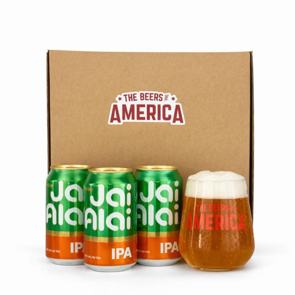 Three cans of Jai Alai IPA and a glass of beer in front of a 'The Beers of America' box.