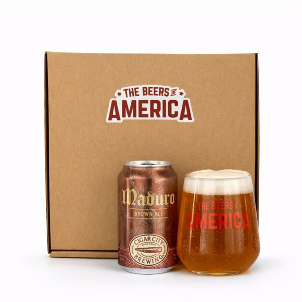 Cigar City Brewing Maduro Brown Ale can and glass with 'The Beers of America' branding on a cardboard box.