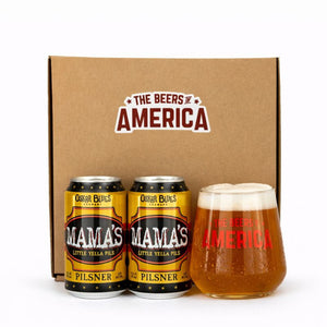 Two cans of 'Mama's Little Yella Pilsner' and a glass of beer in front of a box labeled 'The Beers of America'.