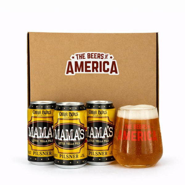 Three cans of 'Mama's Little Yella Pilsner' and a glass of beer in front of a 'The Beers of America' box.