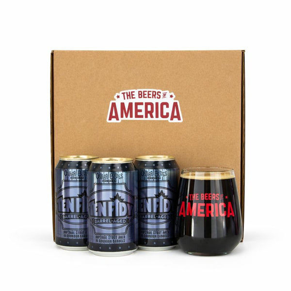 Three cans of 'The Beers of America' barrel-aged beer and a glass in front of a branded box.